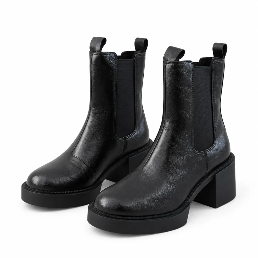 Black leather Chelsea ankle boots for women in US size 4 on a white background